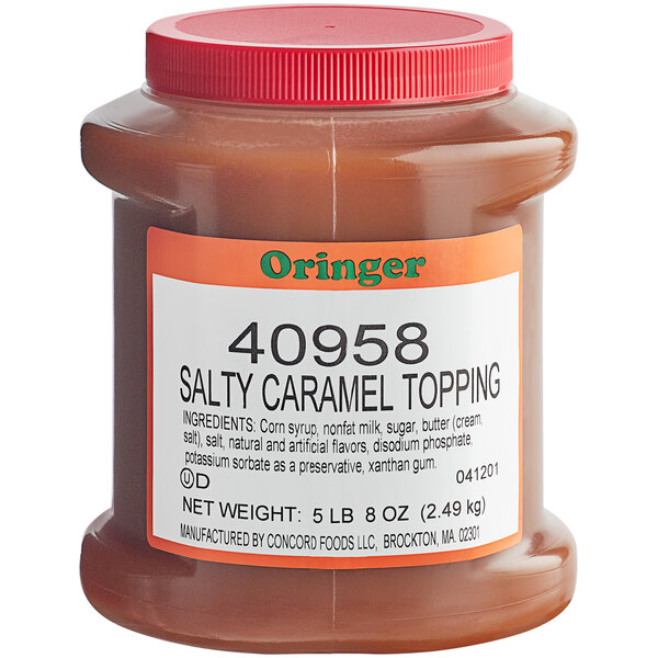 A jar of Oringer salted caramel topping on a counter.