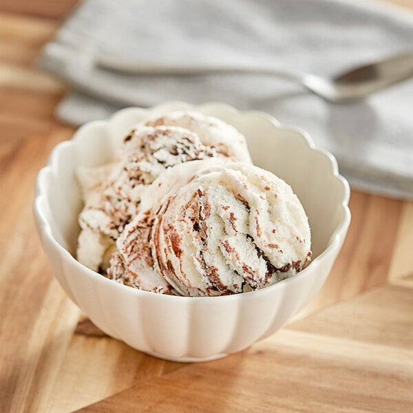 A bowl of Oringer Fudge Crunch Variegate ice cream with a spoon.