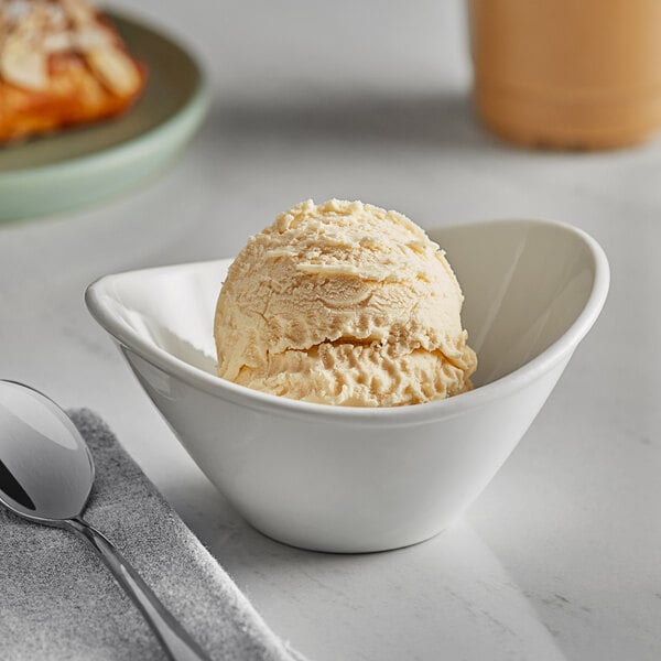 A bowl of Oringer cake batter ice cream with a spoon.