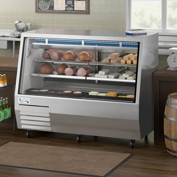 An Avantco stainless steel double-duty deli case with glass doors holding meats and cheese.