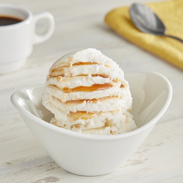 A white bowl with a scoop of Oringer Graham Cracker Variegate on top of ice cream.