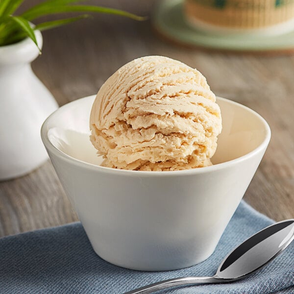 A bowl of Oringer cake batter ice cream with a spoon.