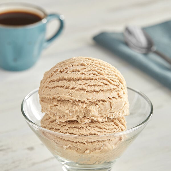 A bowl of Oringer Graham Cracker hard serve ice cream with a spoon on the side.