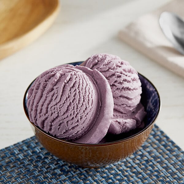 A wooden bowl of purple Oringer blueberry ice cream.