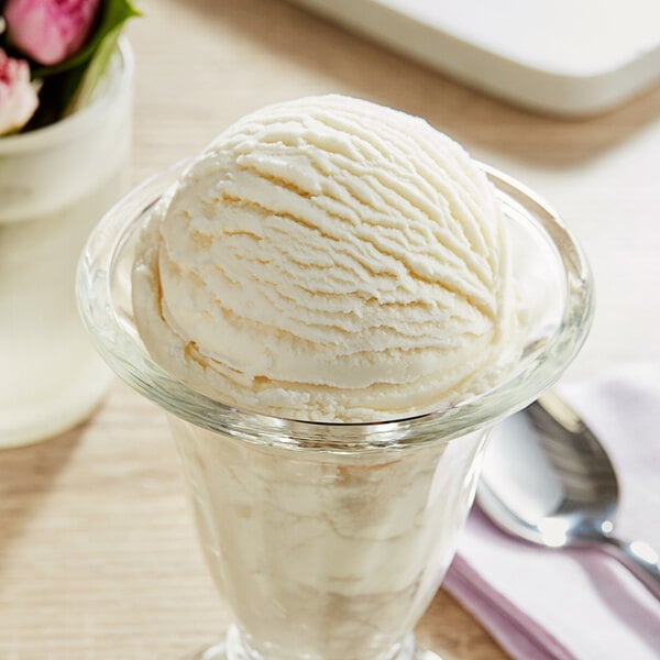 A bowl of Oringer almond ice cream with a spoon in it.