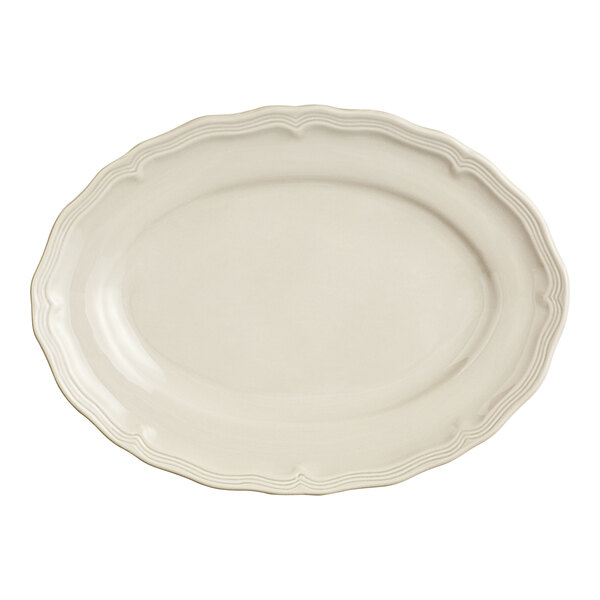 An Acopa Condesa warm gray porcelain oval platter with a scalloped edge.