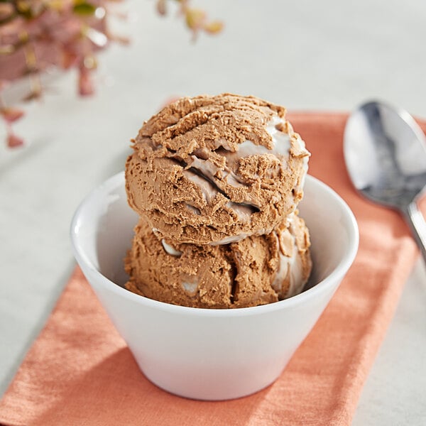 A bowl of brown ice cream with Oringer Buttercream Frosting variegate on top.