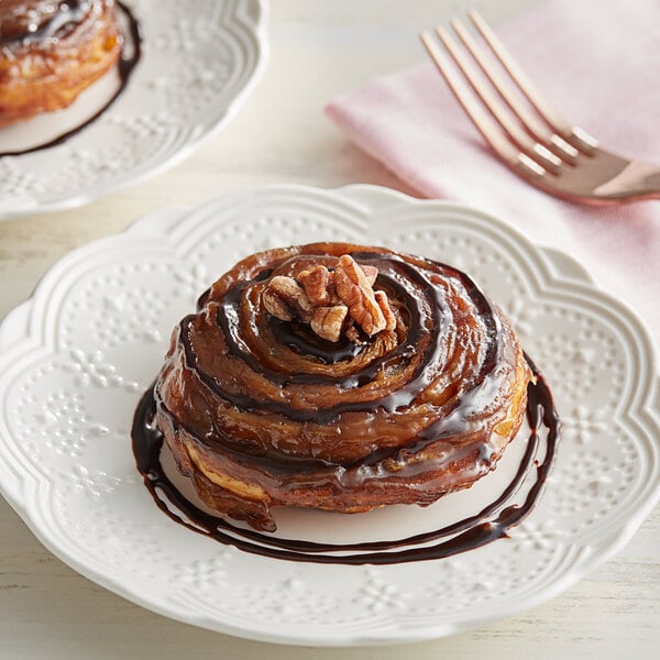 A plate with a chocolate covered doughnut topped with Oringer Fudge.