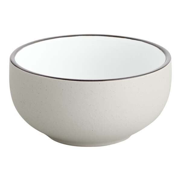 A white stoneware bowl with a brown rim.
