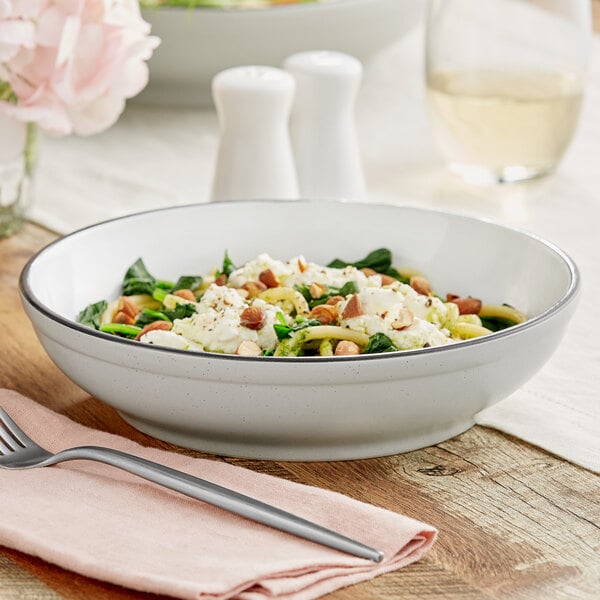 An Acopa Embers grey matte stoneware bowl filled with pasta on a table.