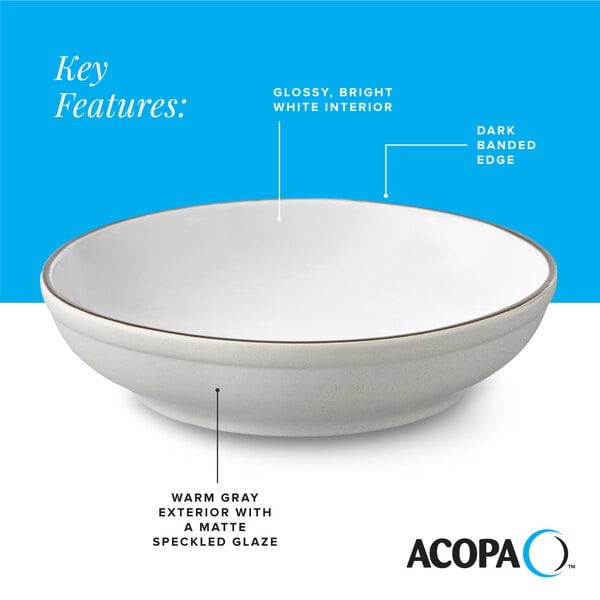 A gray matte stoneware pasta bowl with a glossy white interior and a dark banded edge.