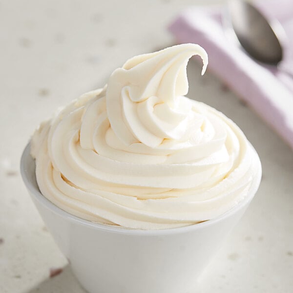 A white bowl of lemon soft serve ice cream.