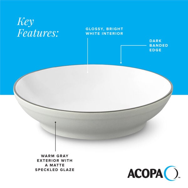 A gray matte stoneware pasta bowl with a glossy white interior and a dark banded edge.