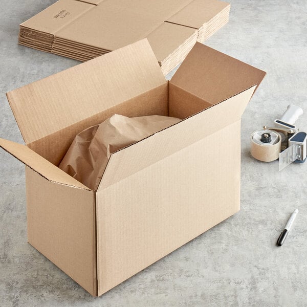 A brown Lavex corrugated cardboard box on a table with a paper bag inside.