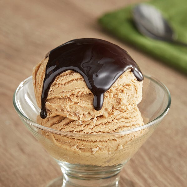 A scoop of ice cream with Oringer Deluxe chocolate syrup.