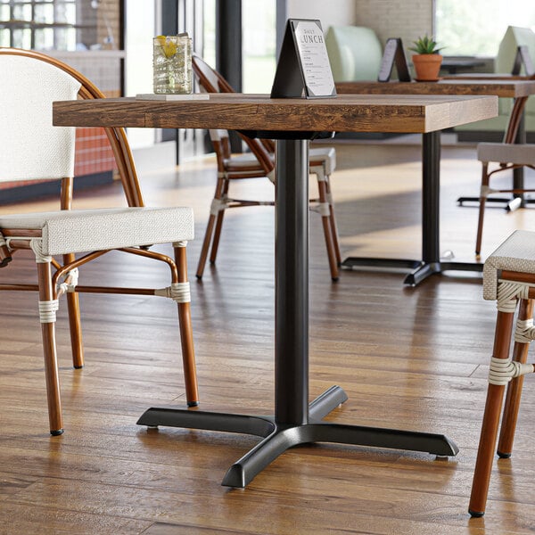A Lancaster Table & Seating black cast iron table base for a restaurant table.