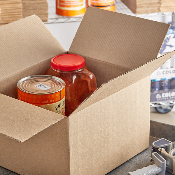 A Lavex cardboard shipping box containing a container and can of food.