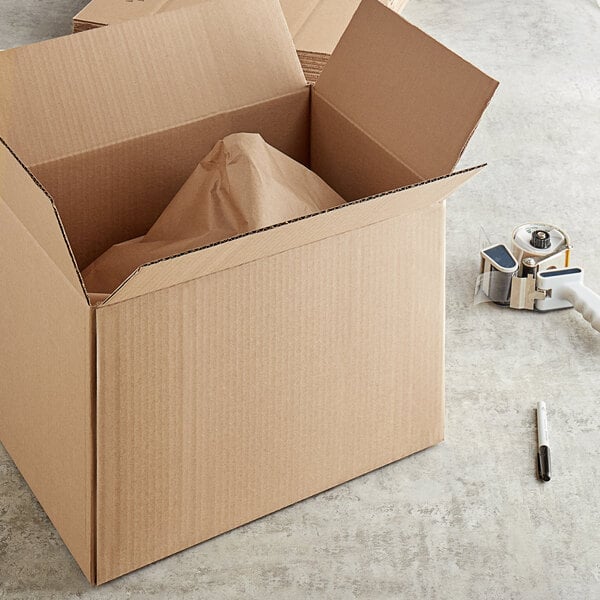 A Lavex kraft cardboard shipping box with a piece of paper inside.