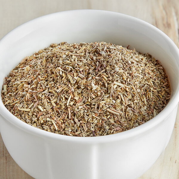 A bowl of McCormick Culinary Italian Seasoning on a wooden table.