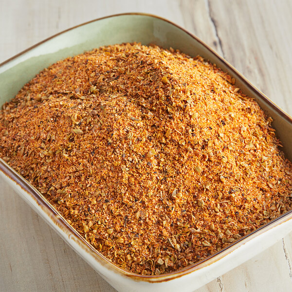 A bowl of McCormick Culinary Bayou Cajun Seasoning on a wood surface.