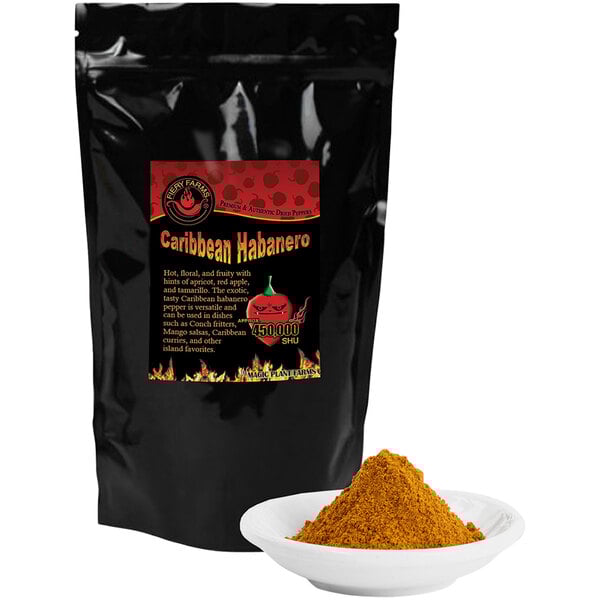 A black bag of Fiery Farms Smoked Red Caribbean Habanero Pepper Powder next to a bowl of yellow powder.