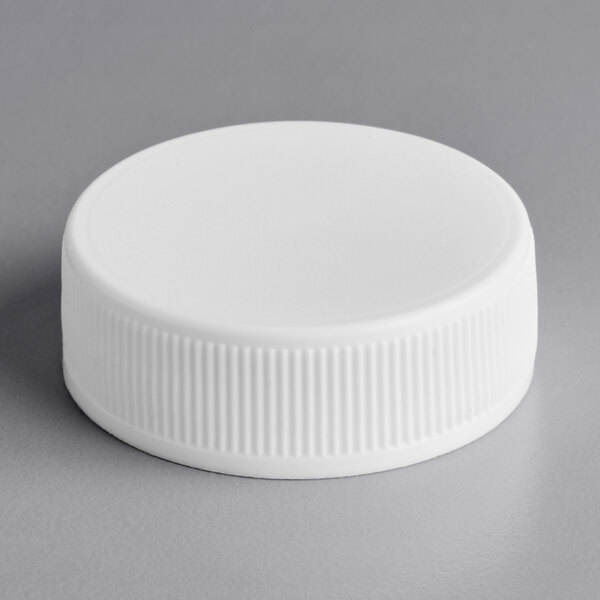 A 33/400 white plastic bottle cap with foam liner.