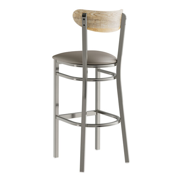 A Lancaster Table & Seating Boomerang bar stool with a dark gray vinyl seat and driftwood back.