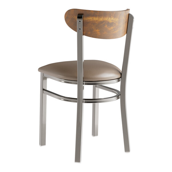 A Lancaster Table & Seating Boomerang chair with a taupe vinyl seat and vintage wood back.