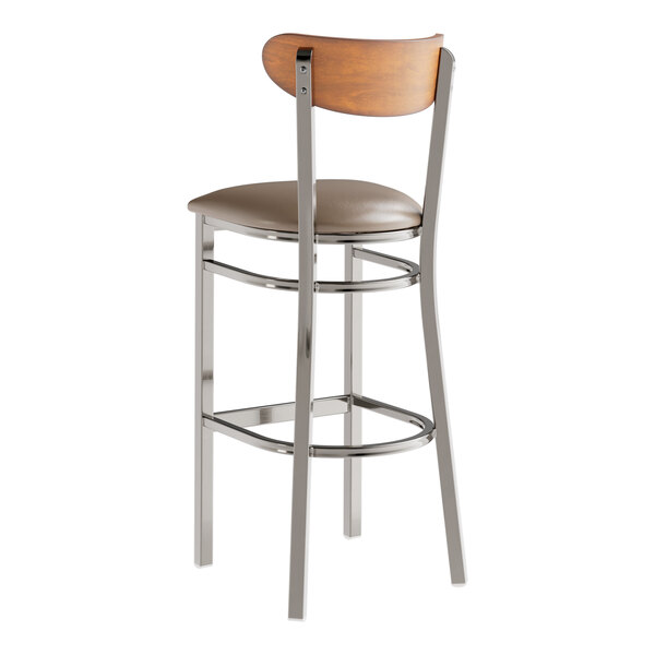 A Lancaster Table & Seating bar stool with a wooden back and taupe vinyl seat.