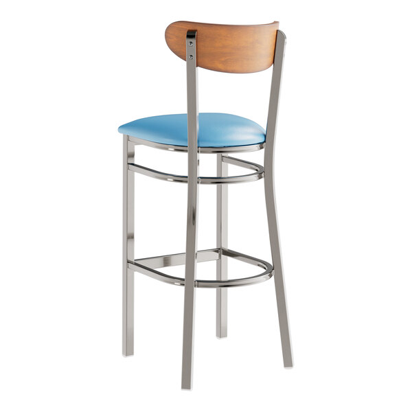 A Lancaster Table & Seating bar stool with a blue vinyl seat and metal frame.