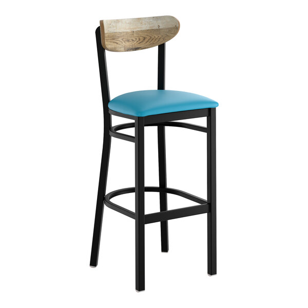 A bar stool with a black metal frame, blue vinyl seat, and a driftwood-finished wooden backrest.