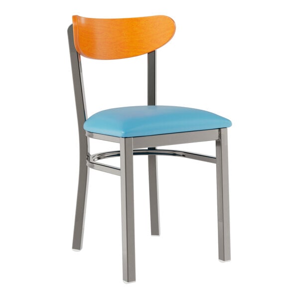 A Lancaster Table & Seating metal chair with a blue vinyl seat and cherry wood back.