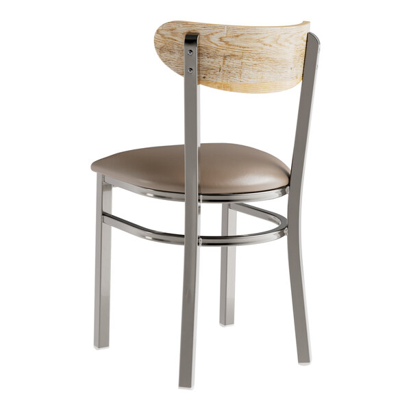 A Lancaster Table & Seating metal chair with a driftwood seat and taupe cushion.