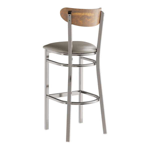 A Lancaster Table & Seating bar stool with a wooden back and cushioned seat.