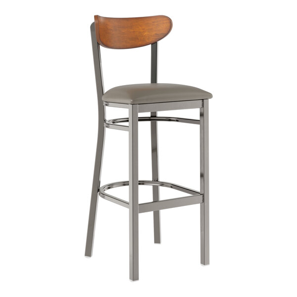 A Lancaster Table & Seating bar stool with a wooden back and cushioned seat.