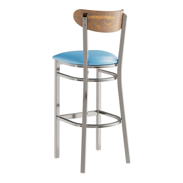 A Lancaster Table & Seating bar stool with a blue vinyl seat and metal frame.