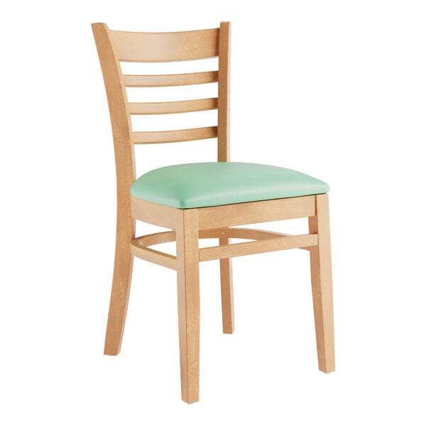 A Lancaster Table & Seating wooden chair with a seafoam green cushion.