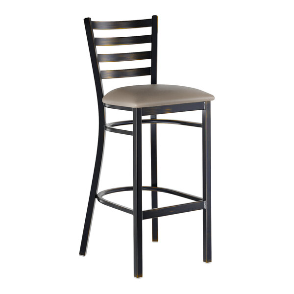 A metal ladder back bar stool with a distressed copper finish and a dark gray vinyl padded seat.