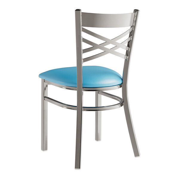 A Lancaster Table & Seating metal cross back chair with a blue vinyl padded seat.
