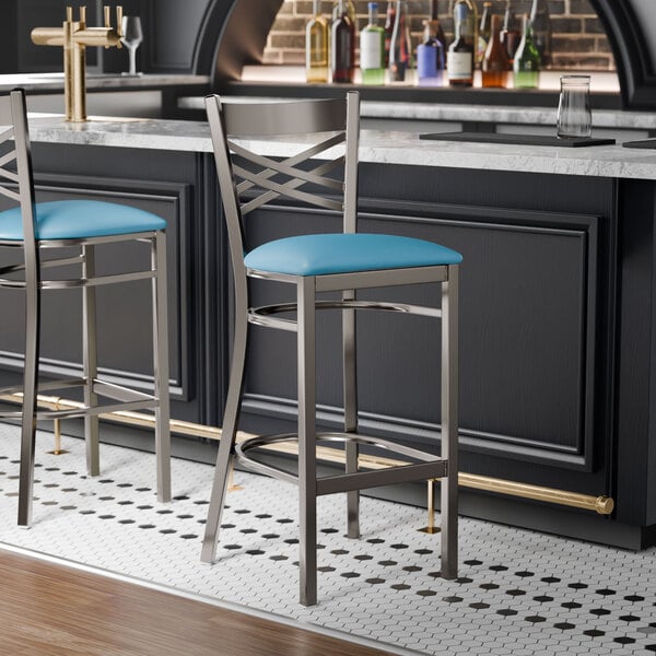 Lancaster Table & Seating Clear Coat Finish Cross Back Bar Stool with 2 1/2" Blue Vinyl Padded Seat - Assembled