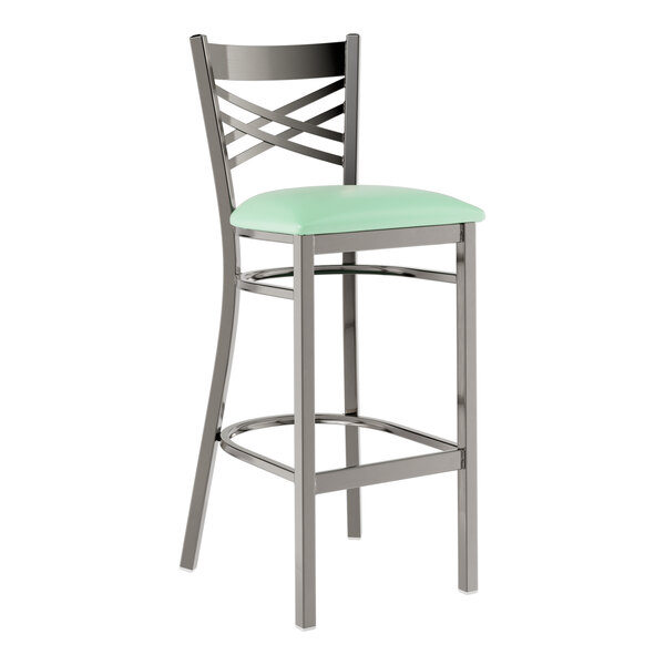 A Lancaster Table & Seating black metal bar stool with a seafoam green vinyl padded seat.
