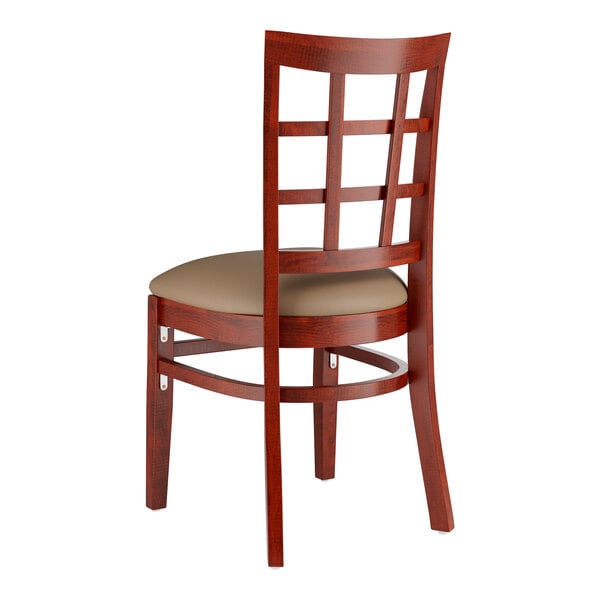 A Lancaster Table & Seating mahogany wood chair with taupe vinyl seat and window back.