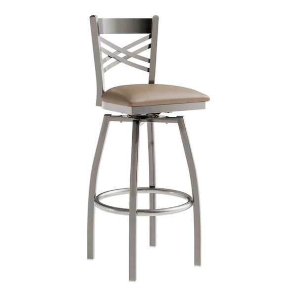 A Lancaster Table & Seating cross back swivel bar stool with taupe vinyl padded seat.