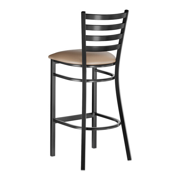 A black metal bar stool with a ladder back design and a taupe vinyl padded seat.