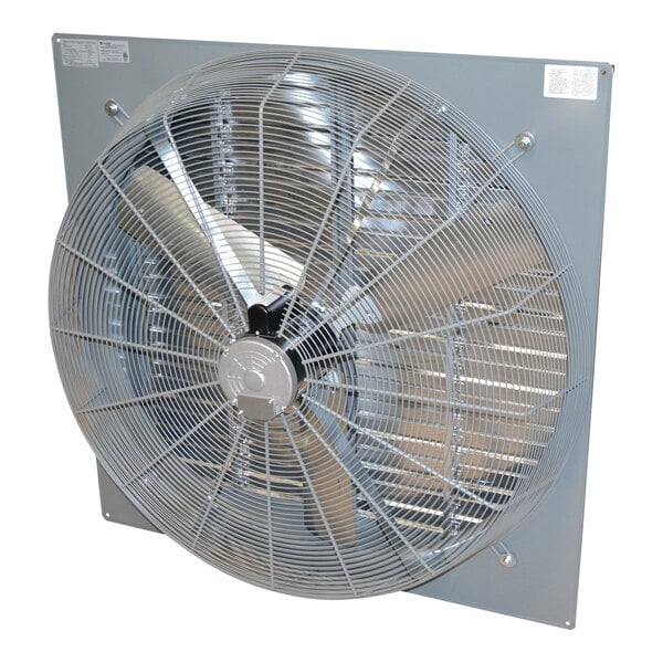 A large industrial wall-mounted exhaust fan with a protective metal grille and three visible blades.