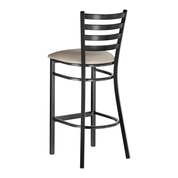 A black metal bar stool with a ladder back design and a dark gray vinyl padded seat.