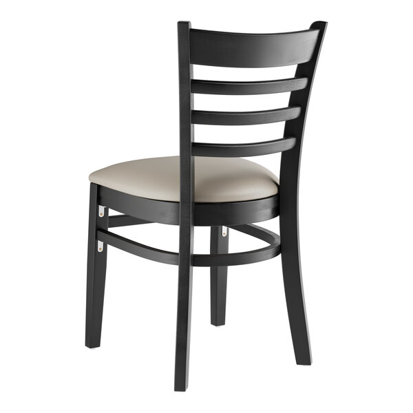 A black Lancaster Table & Seating wood ladder back chair with a dark gray vinyl seat.