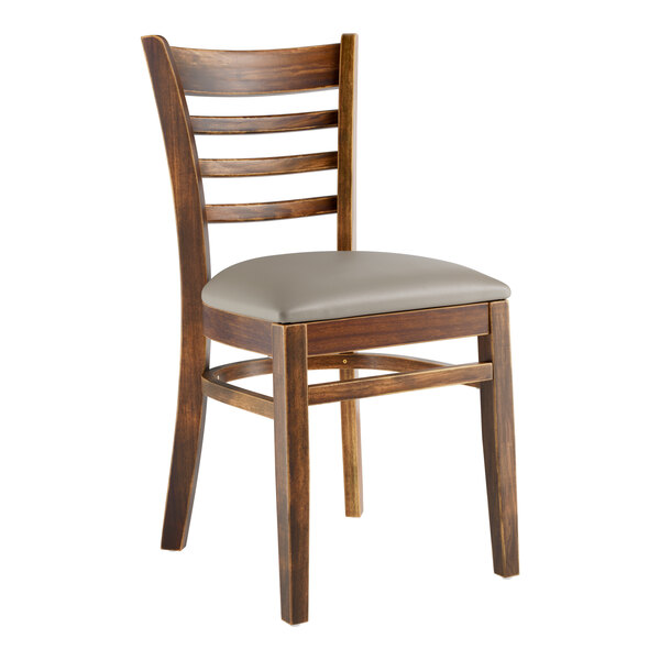 A Lancaster Table & Seating wooden ladder back chair with a dark gray vinyl seat.