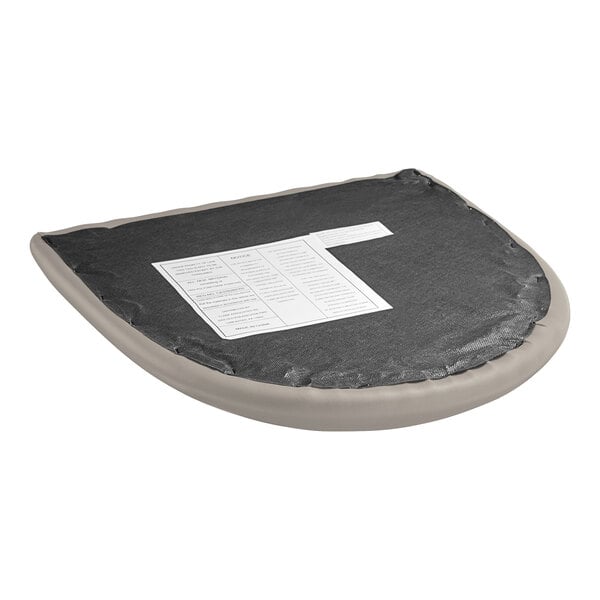 A detached dark gray vinyl seat cushion for a Lancaster Table & Seating wood chair.