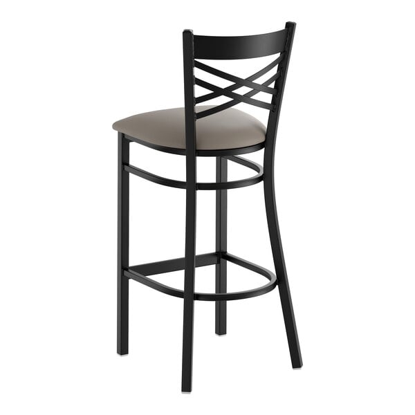 A black metal bar stool with a cross back design and a dark gray vinyl padded seat.